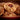 Cookies with a red filling in a bowl on a wooden surface