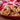 Gem cookies on a red plate with a checkered cloth in the background