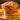 Stack of pfeffernusse cookies on a yellow plate with a blurred background