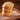 Stack of sugar cookies on a wooden board with a brown background