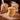Stack of cookies on a wooden board with wrapped cookies in the background.
