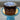 Chocolate cake on a blue stand with a blurred background